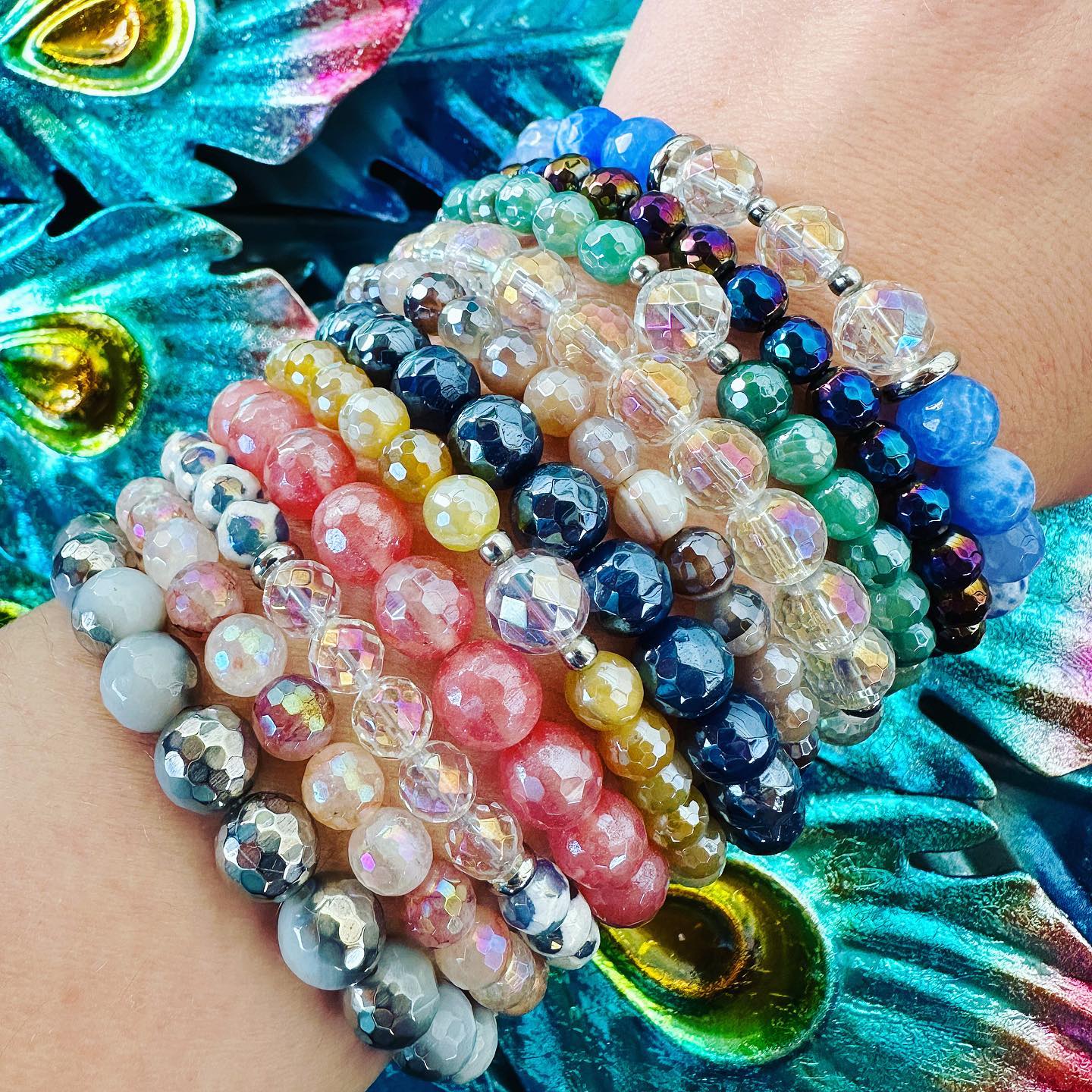 Featherly gemstone beaded stacker bracelets in a stack of vibrant colors 