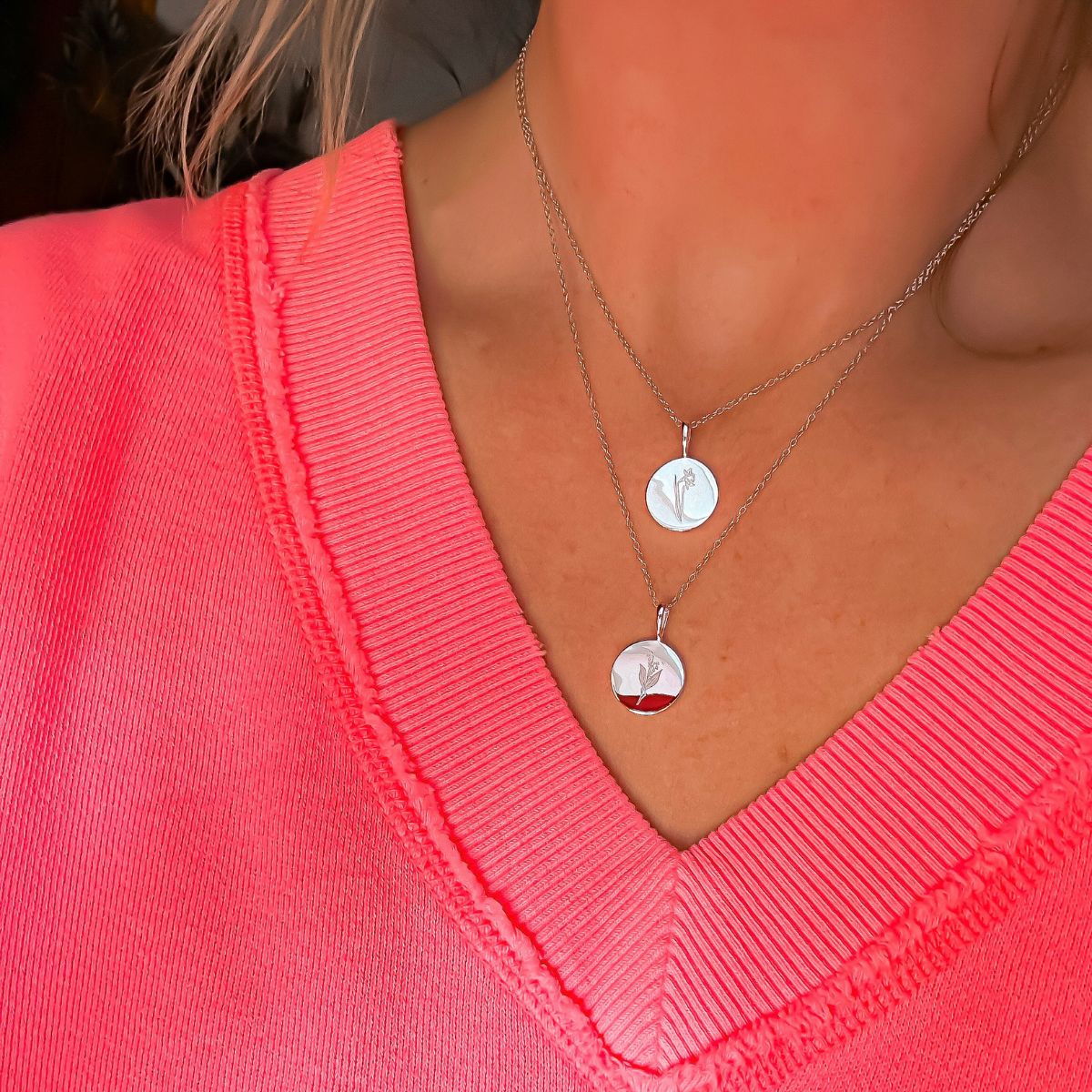 Featherly Sterling Silver birth month flower necklaces layered on model for December birth flower and May birth flower