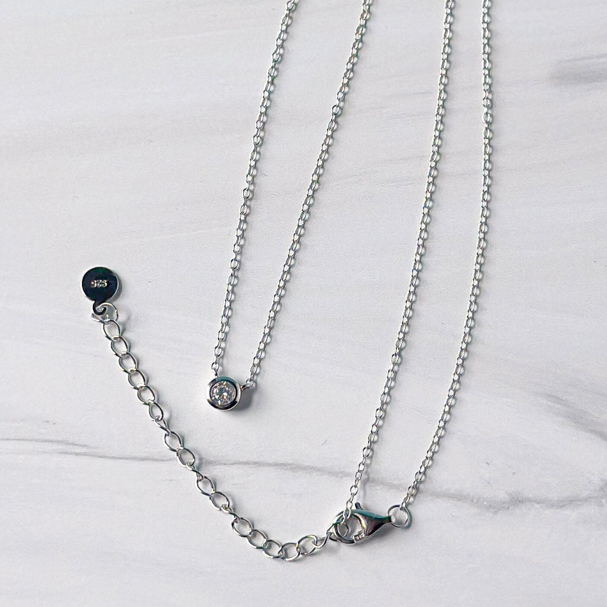 Featherly adjustable cubic zirconia bezel necklace in 925 sterling silver showing the 2 inch extender