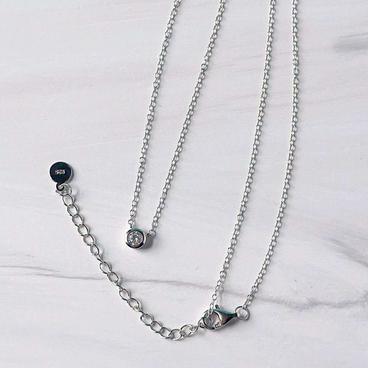  Featherly adjustable cubic zirconia bezel necklace in 925 sterling silver showing the 2 inch extender