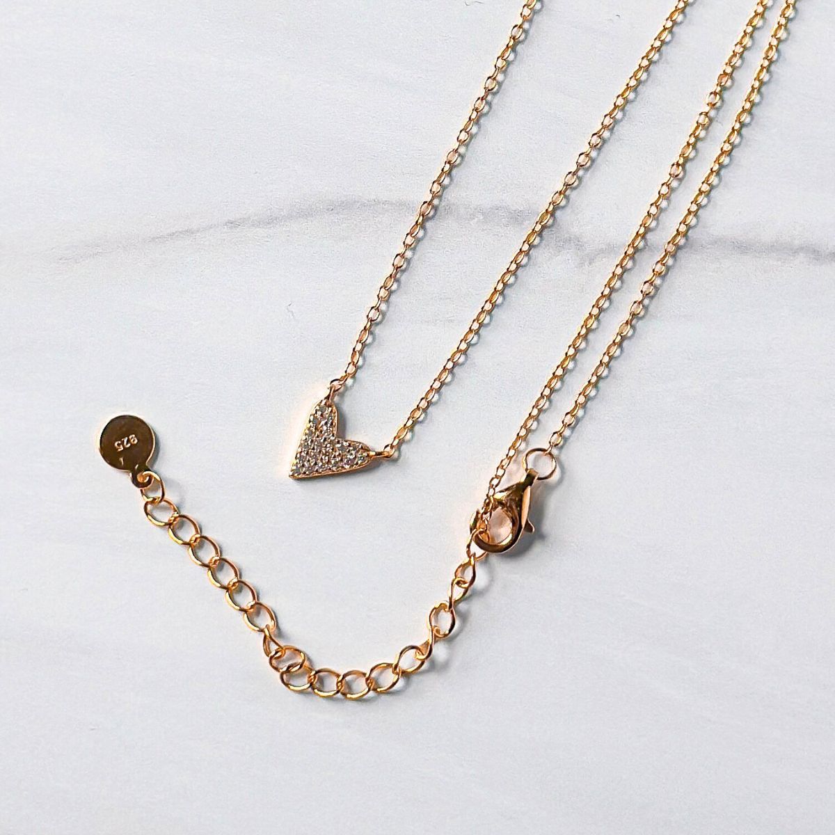 Featherly adjustable cubic zirconia heart necklace in gold showing the 2 inch extender