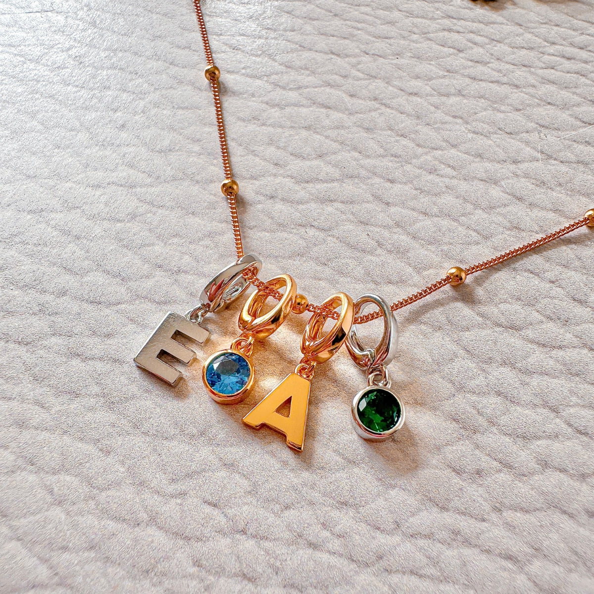 birthstone charm necklace and initial charm necklace in sterling silver and gold
