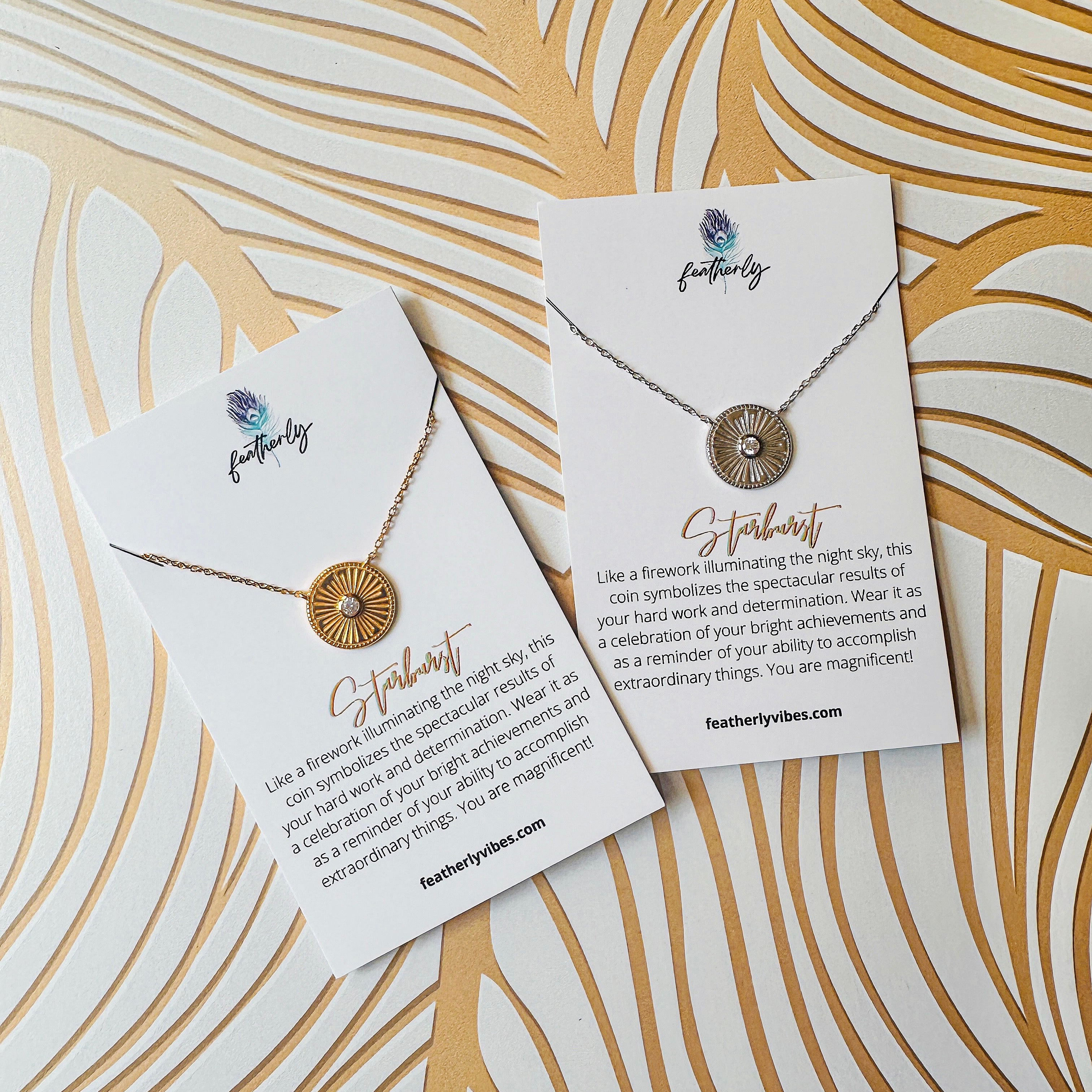 Featherly silver and gold starburst coin necklaces on meaning cards