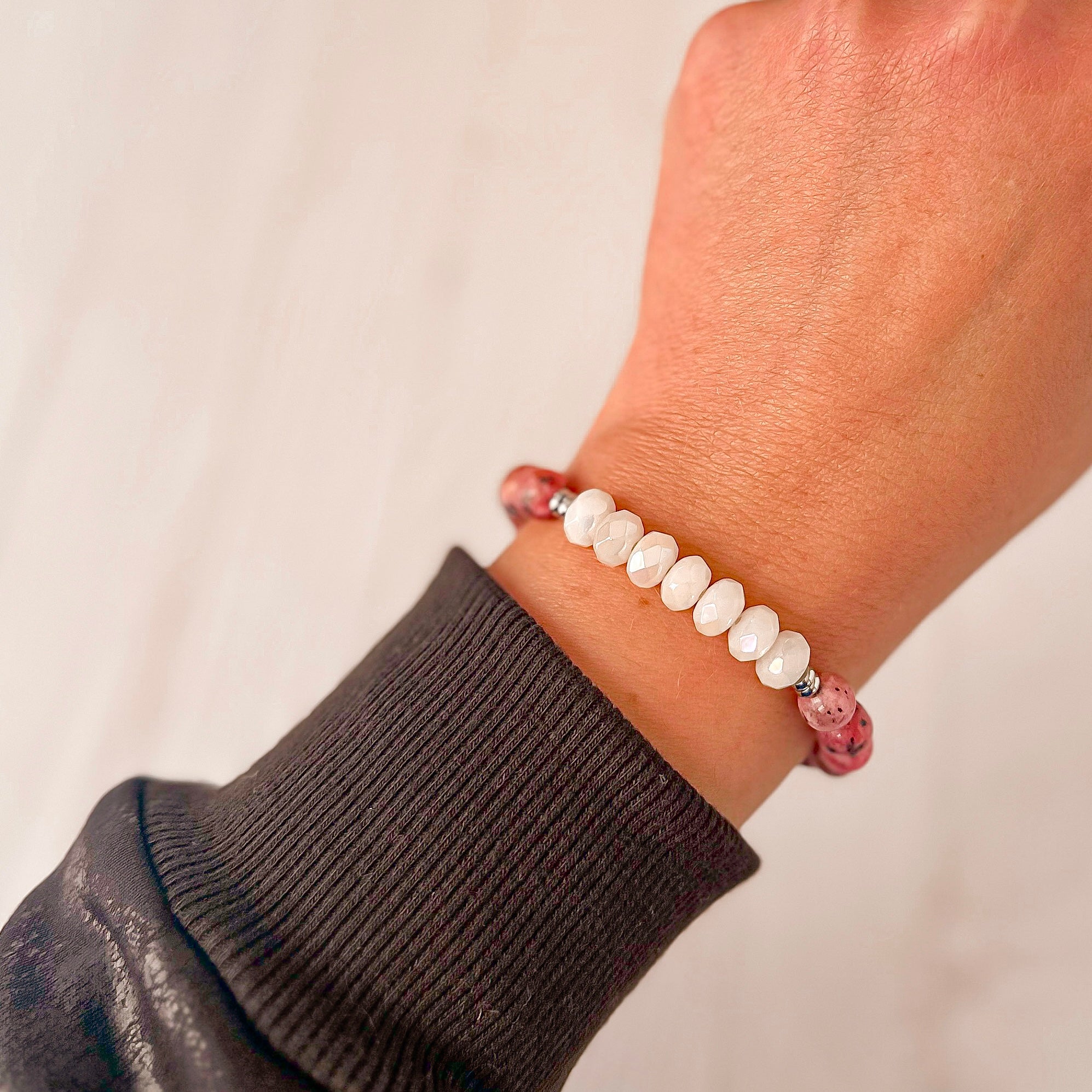 Featherly White Jade and Pink Dalmatian Jasper Positive Purpose Stretch Beaded Stacker Bracelet on model