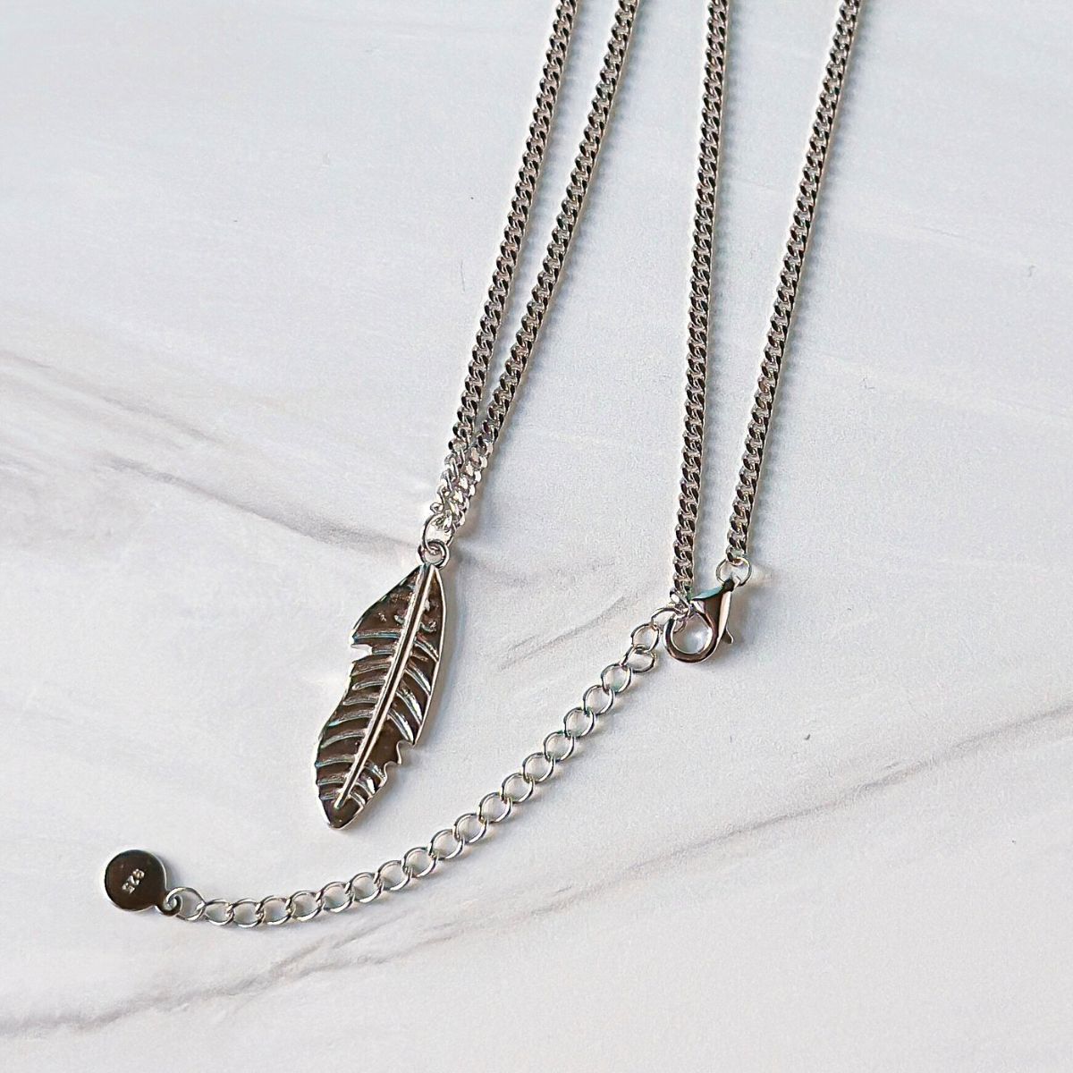 Featherly feather necklace in sterling silver showing the 2 inch extender