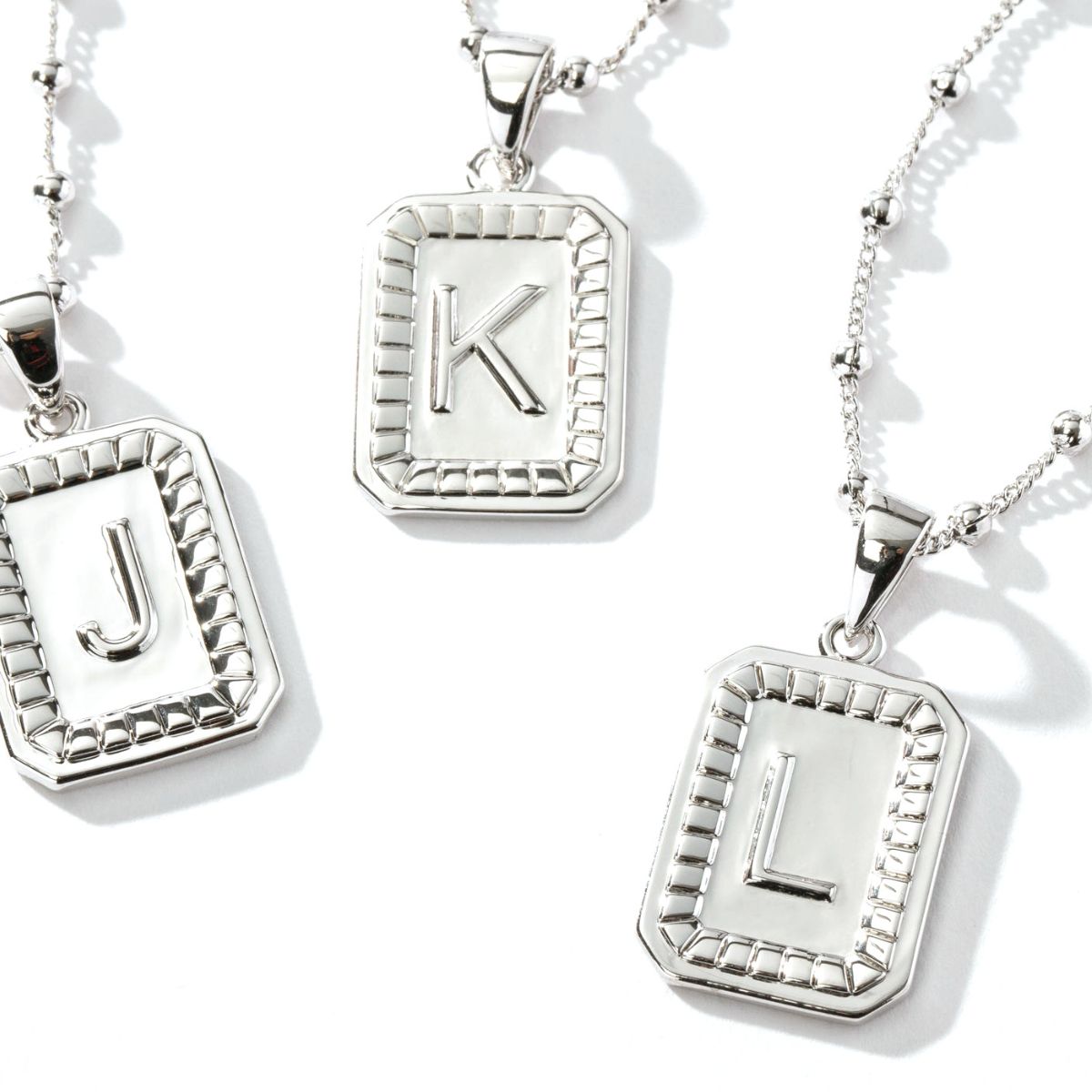 silver initial necklaces in sterling silver letters J, K, and L