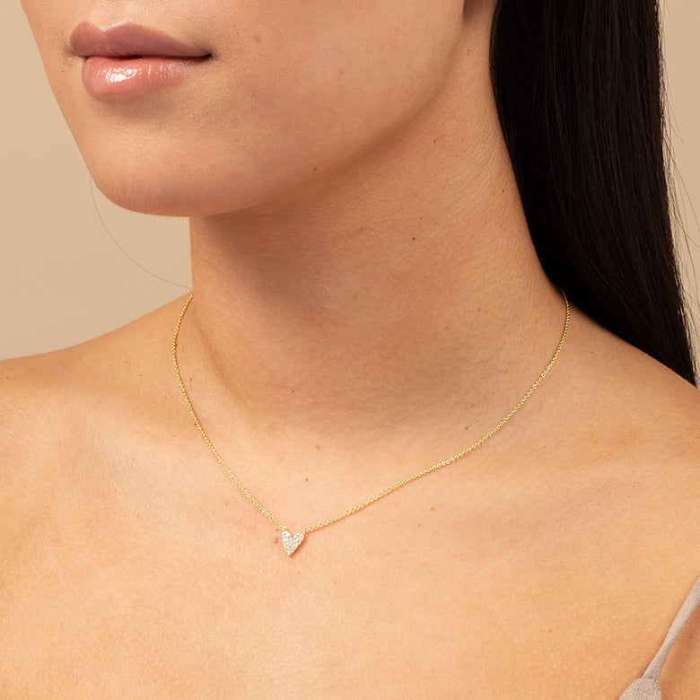 Model wearing the Featherly adjustable cubic zirconia heart necklace in gold